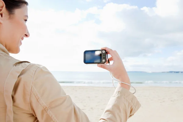 Woman holding a consumer digital photo camera