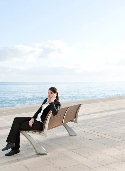 Businesswoman sitting down on a bench