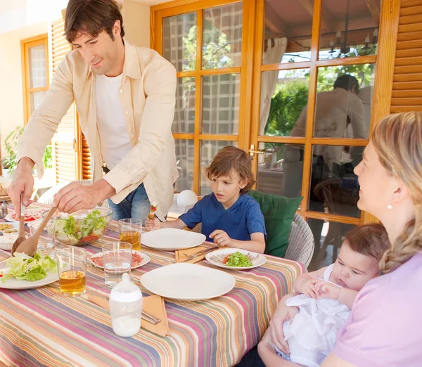 Family have lunch in the home