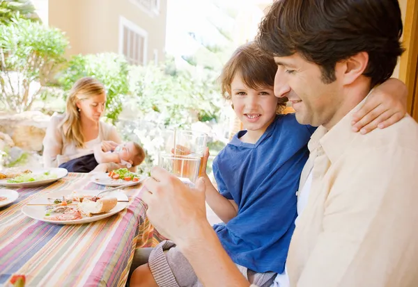 Family of four gathering eating