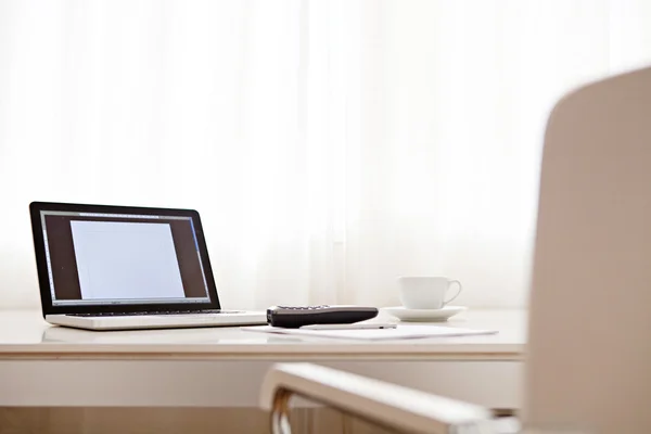 Work desk interior with a laptop computer