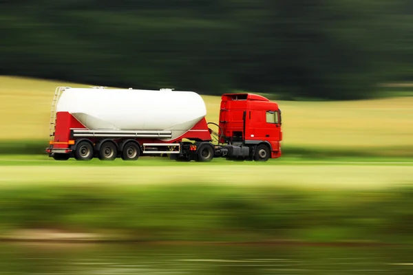 Large white cistern truck speeding on highway