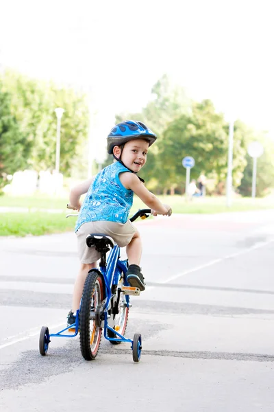Baby boy on bike with crash helmet