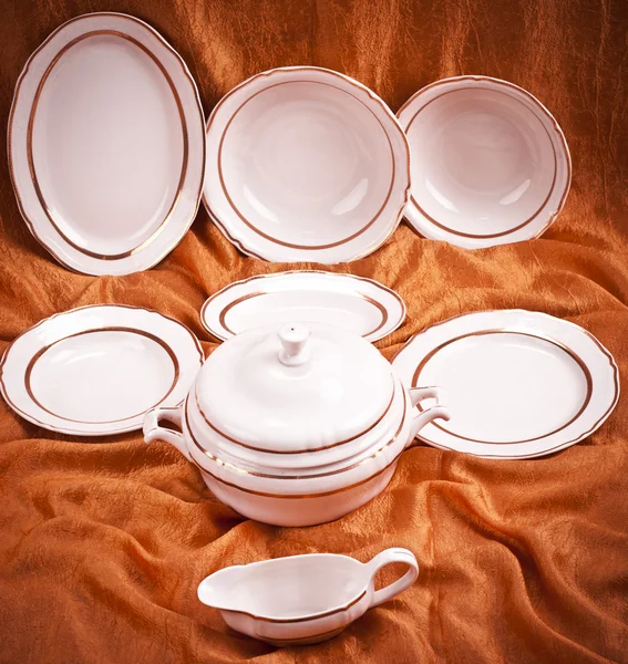 Dinnerware set on orange background