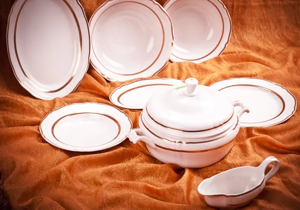 Dinnerware set on orange background