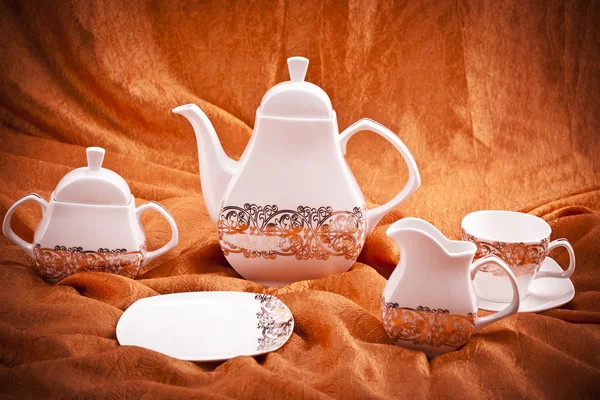 Dinnerware set on orange background