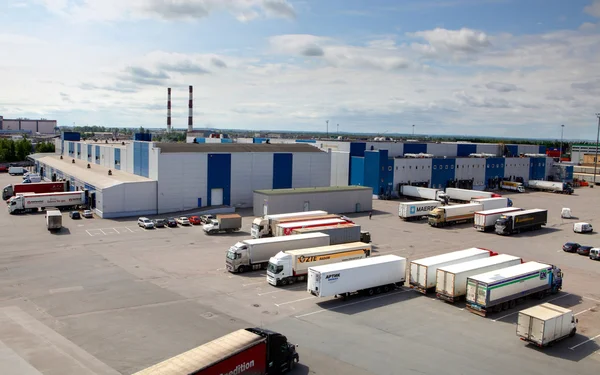 Cargo terminal in a large warehouse complex. Trucks unload, unlo