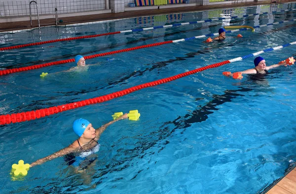 Female group training in the indoor swimming pool, editorial use