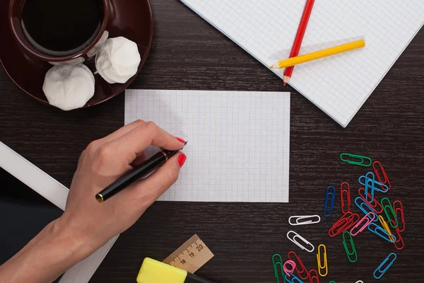 Woman's hand writing on paper