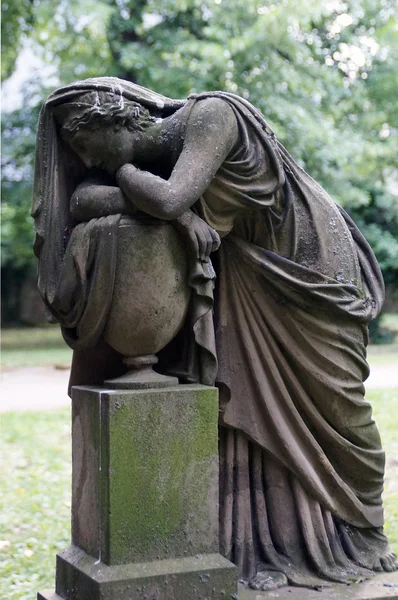 An old, weathered statue is an impressive mourning.