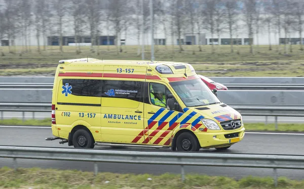 Mercedes Ambulance driving down the road