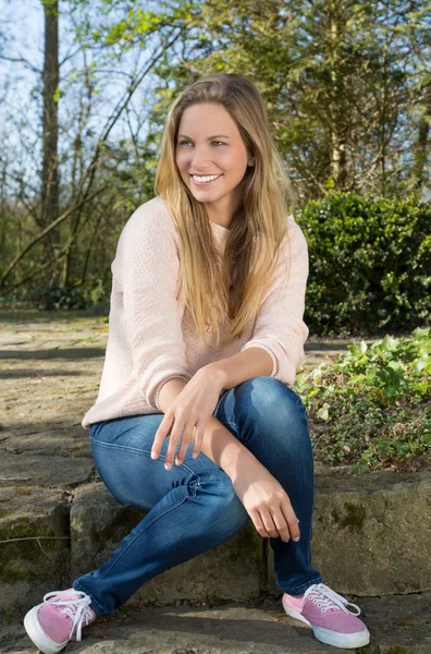 Woman sitting outside in a park