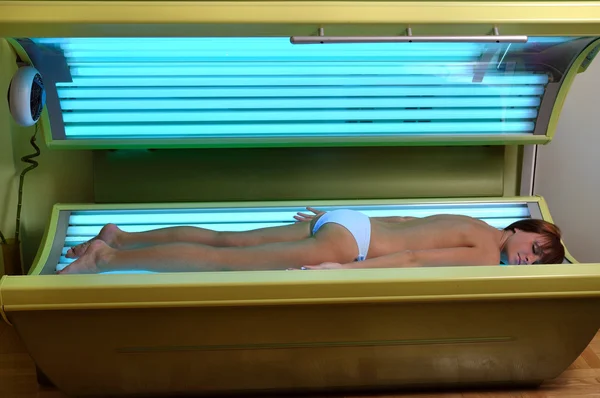 Beautiful girl laying in a solarium