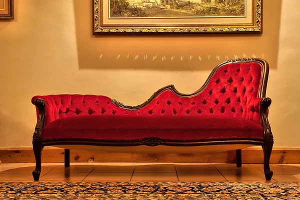 Expensive red sofa under painting