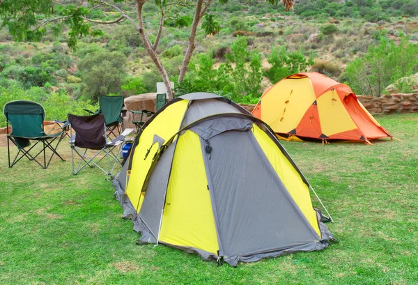Two tents and chairs on camping site