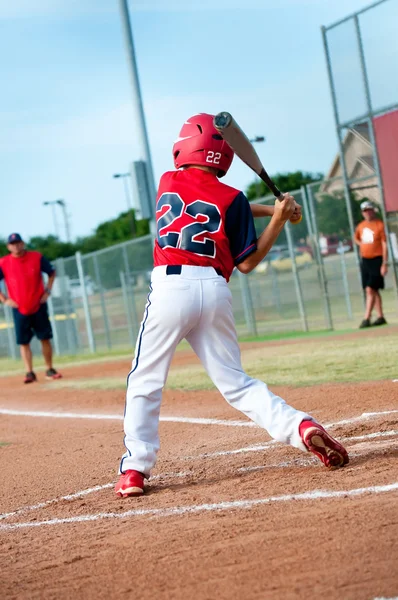 Young baseball player swinging the bat