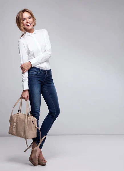 Beautiful happy business woman holding a bag