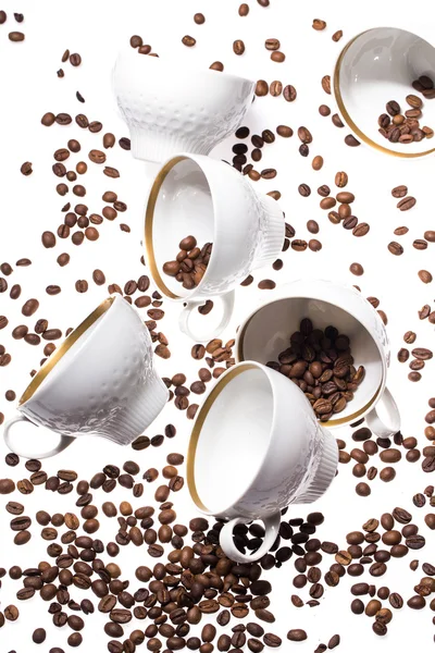 Falling coffee cups and beans