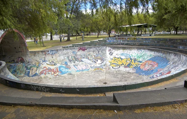 Old skateboard park painted with graffiti.