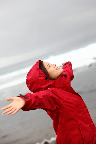 Fall woman in rain happy by ocean — Stock Photo #22312915