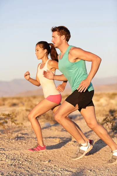 Runners couple running in trail run outside