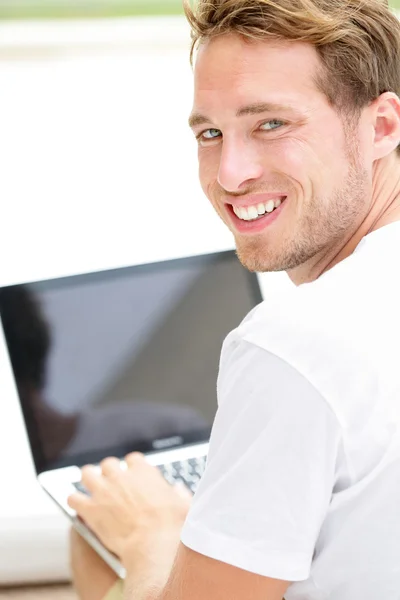 Laptop man smiling happy using computer outside