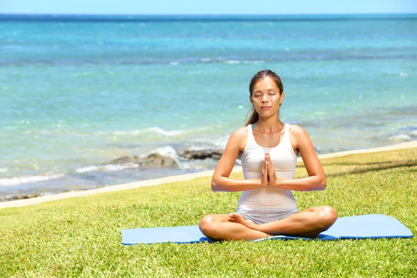 Yoga woman meditating woman relaxing by sea
