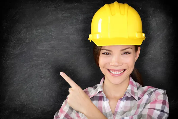 Female construction worker or engineer showing