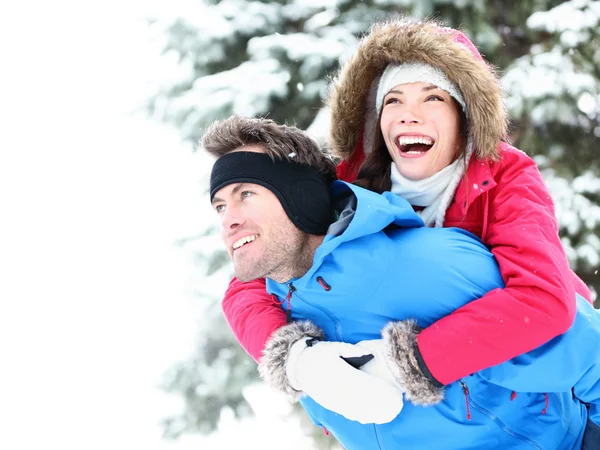 Winter couple happy piggyback