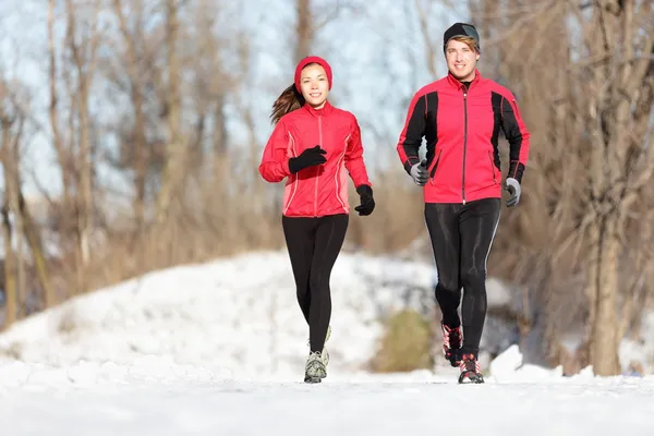 Sport couple running in winter