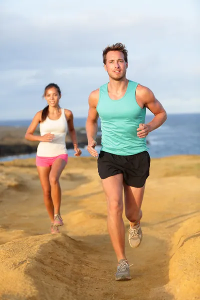 Runners couple jogging for fitness running outside