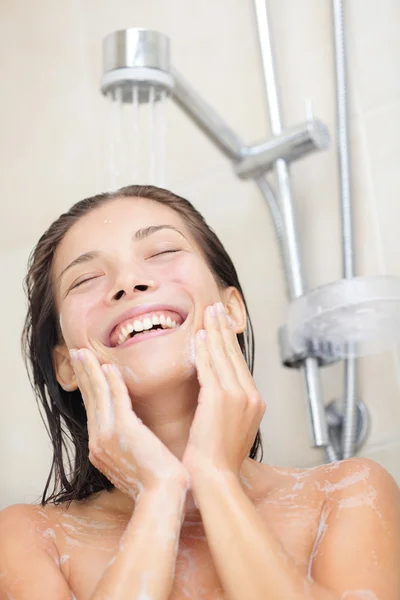 Woman washing face in shower
