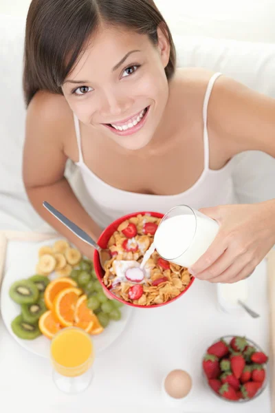 Woman eating breakfast in bed — Stock Photo #21568909