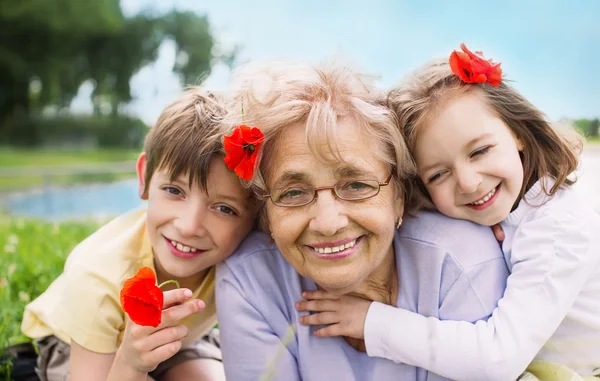 Happy grandmother with grandchildren outdoors