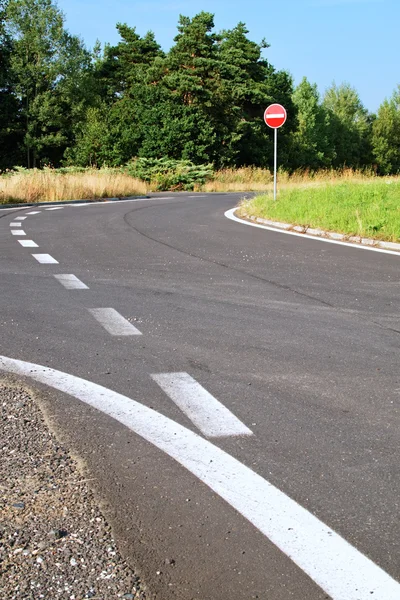 Asphalt access road with a traffic sign no entry