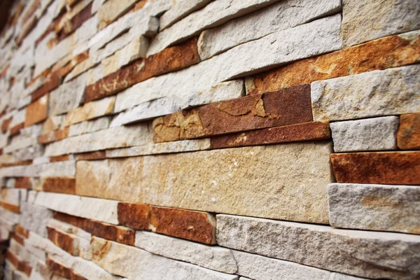 Brown-yellow stacked stone wall