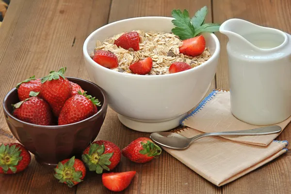 Bowl of cereal with milk and strawberries