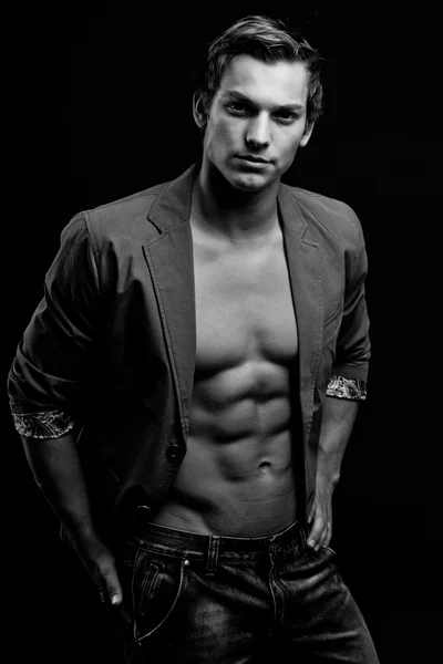 Black and white portrait of sexy man with open jacket over dark