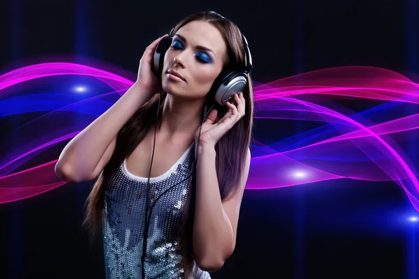 Woman DJ enjoying the music in the headphones