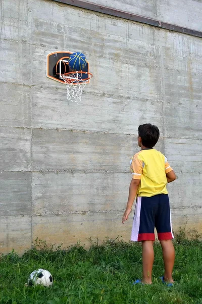 Child plays basketball