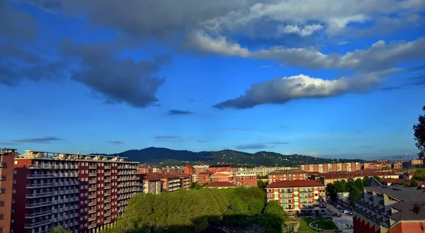 Turin. periphery. Fiat Mirafiori. City. clouds. sky. palaces. hill