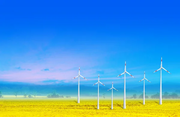 Wind turbines farm green electricity on yellow field