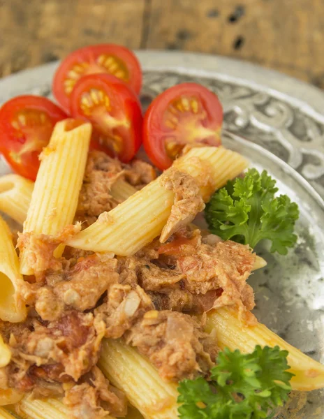 Tuna pasta with tomatoes in silver plate