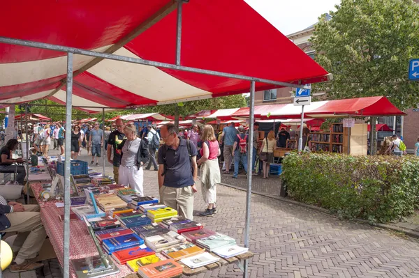 Shopping people at market stalls of historic book fair