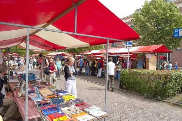 Shopping people at market stalls of vintage book fair