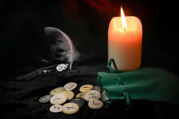 Rune stones with candle
