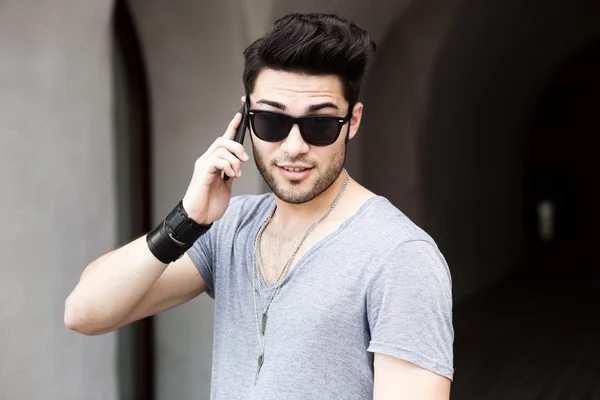 Handsome young man talking on a smartphone