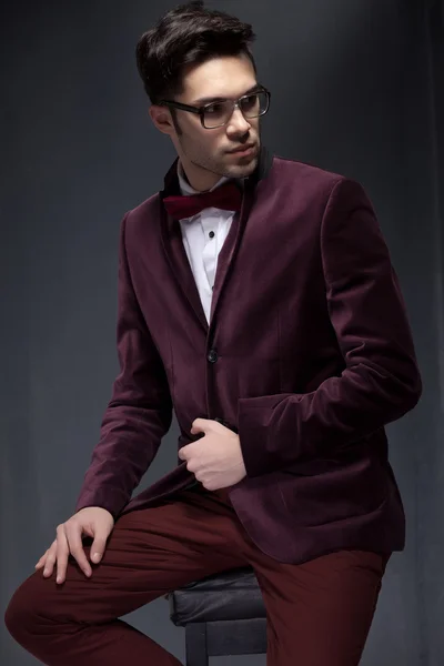 Sexy fashion male model dressed elegant - casual posing against wall
