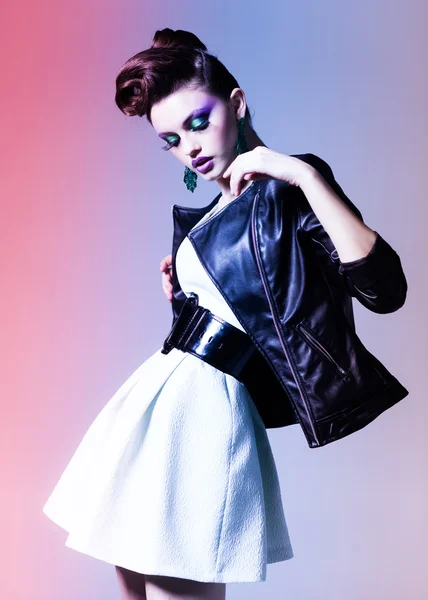 Beautiful woman dressed elegant punk posing in the studio