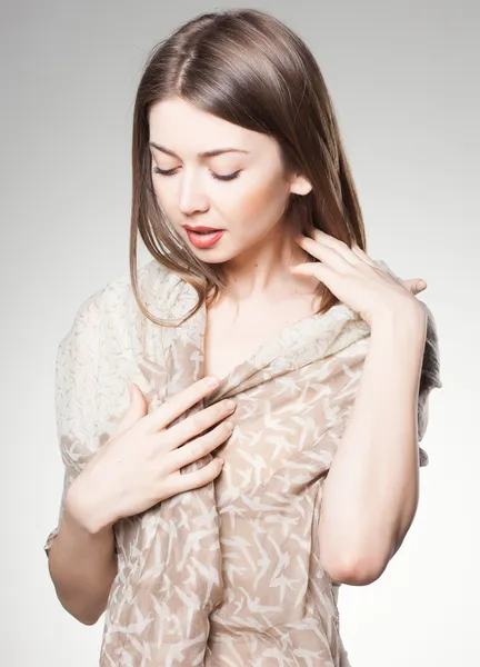 Pretty woman wearing scarf -studio shot on grey background